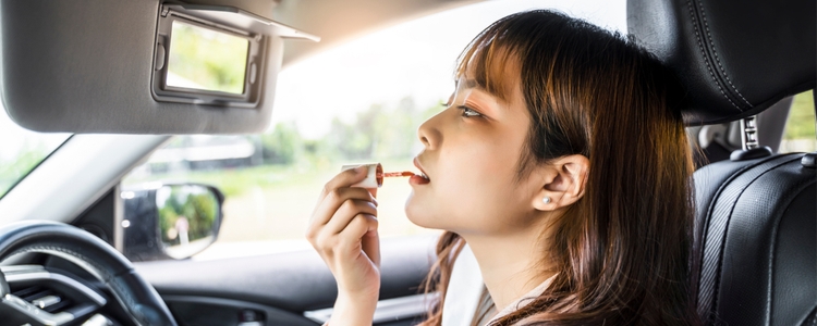 woman driving distracted putting on makeup woman driving distracted putting on makeup